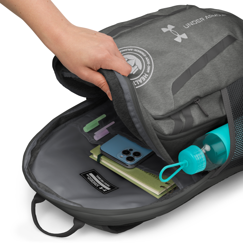 Gray Under Armour backpack with items like a phone, water bottle, and notebooks inside.