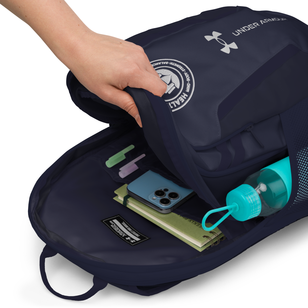 Navy Under Armour backpack with items like a phone and water bottle inside, on a white background