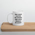 A white ceramic coffee mug with black text reading &