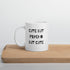 A white ceramic mug with the text &
