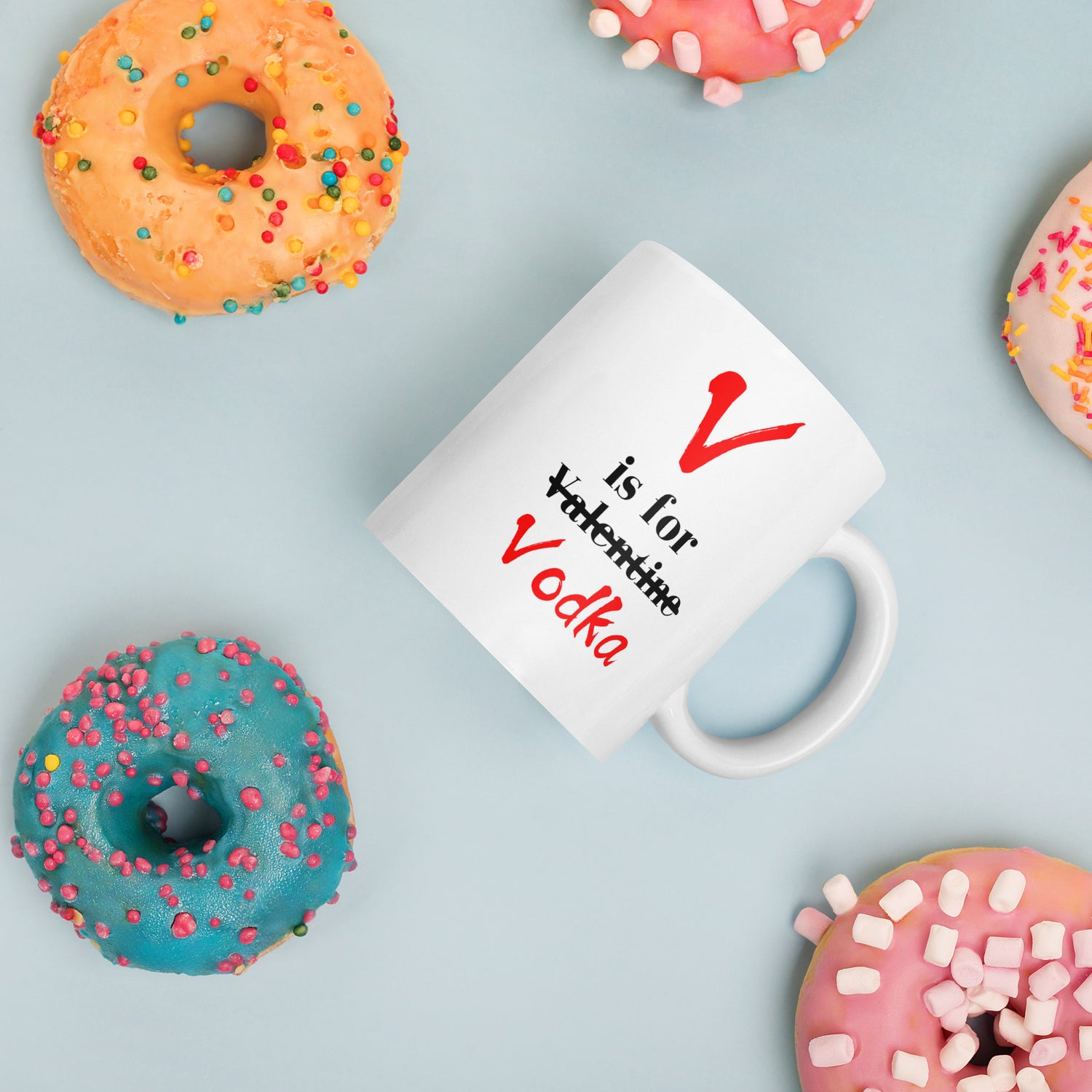 "White ceramic coffee mug with black text saying V Is For Valentine crossed out Vodka"