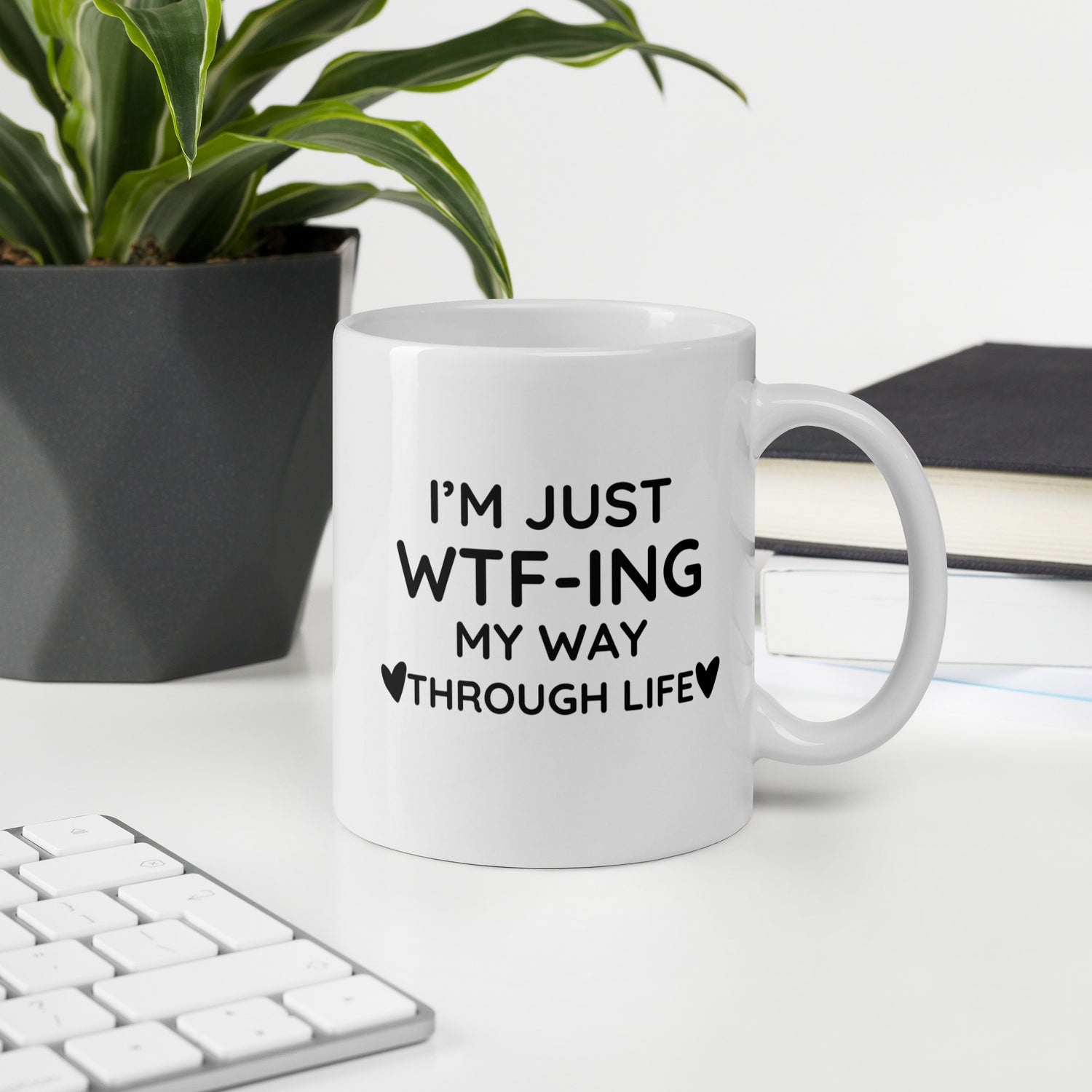 "White ceramic coffee mug with black text saying I&