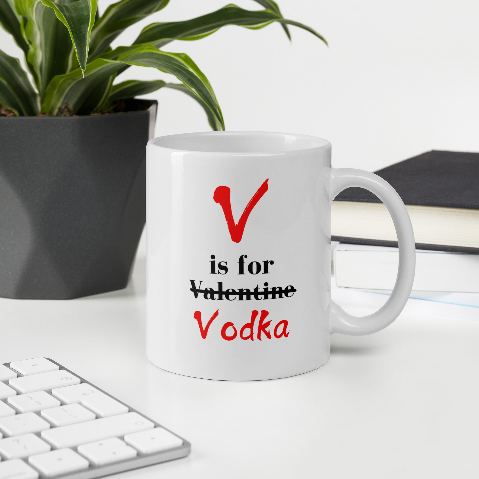 "White ceramic coffee mug with black text saying V Is For Valentine crossed out Vodka"