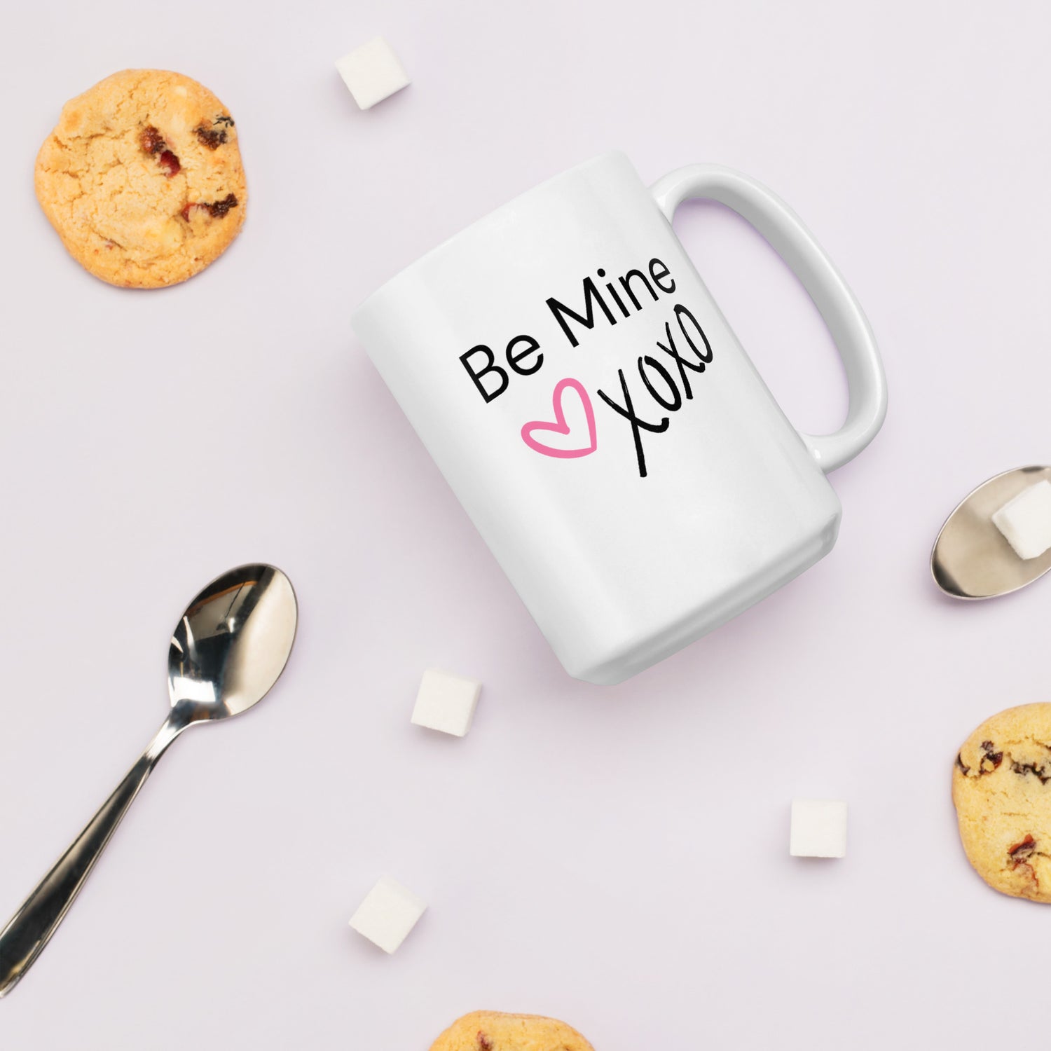 White ceramic coffee mug with black text saying Be Mine xoxo