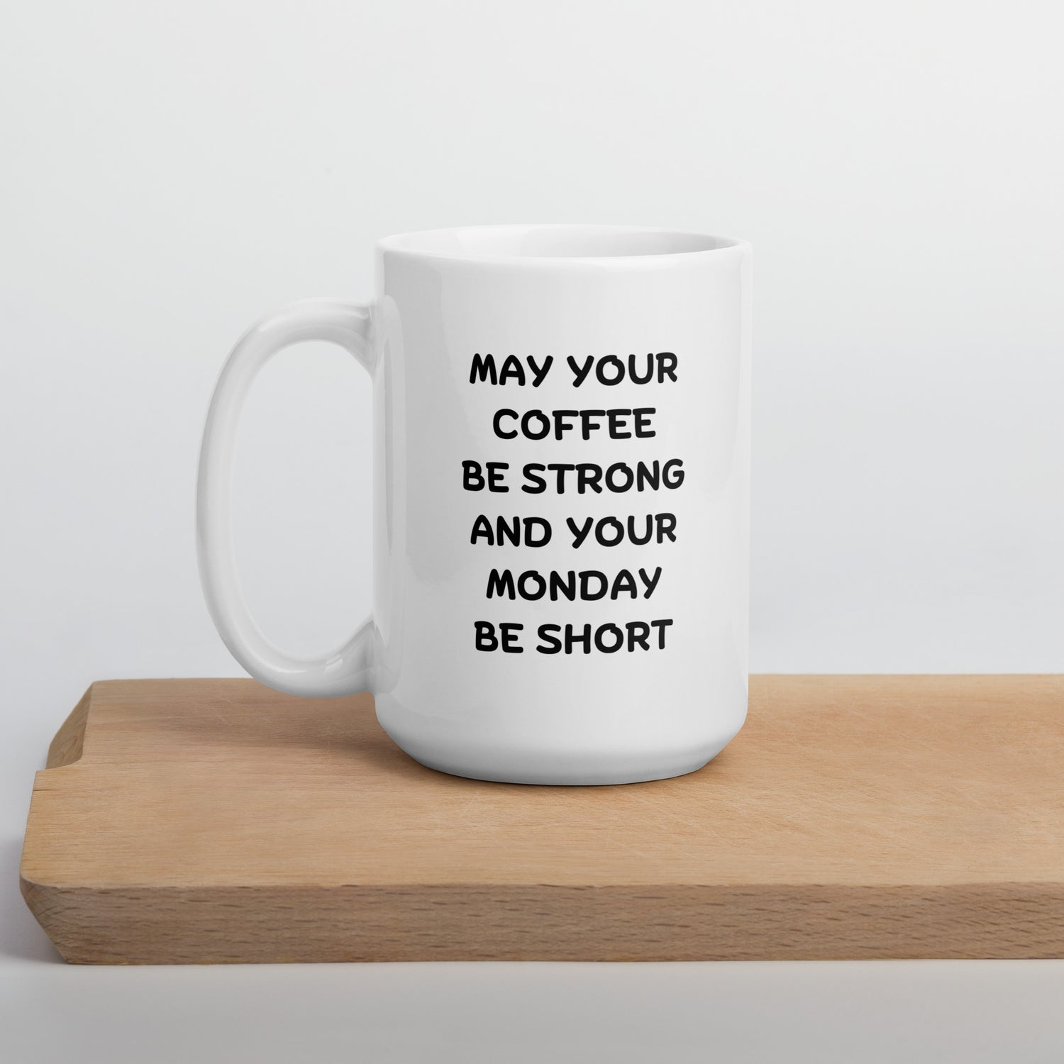 A white ceramic coffee mug with black text reading &