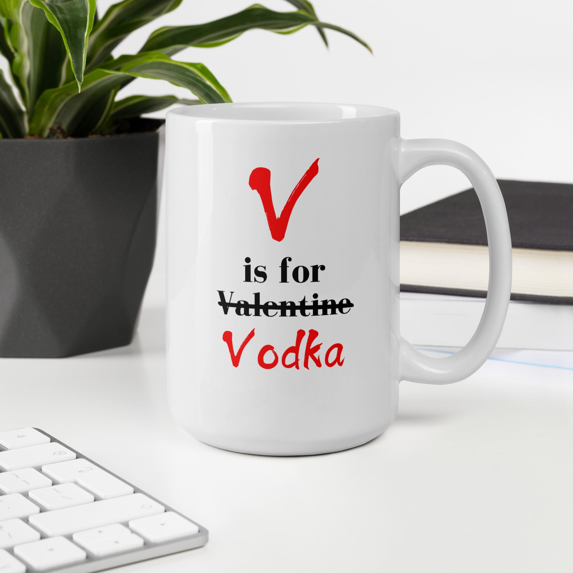 "White ceramic coffee mug with black text saying V Is For Valentine crossed out Vodka"