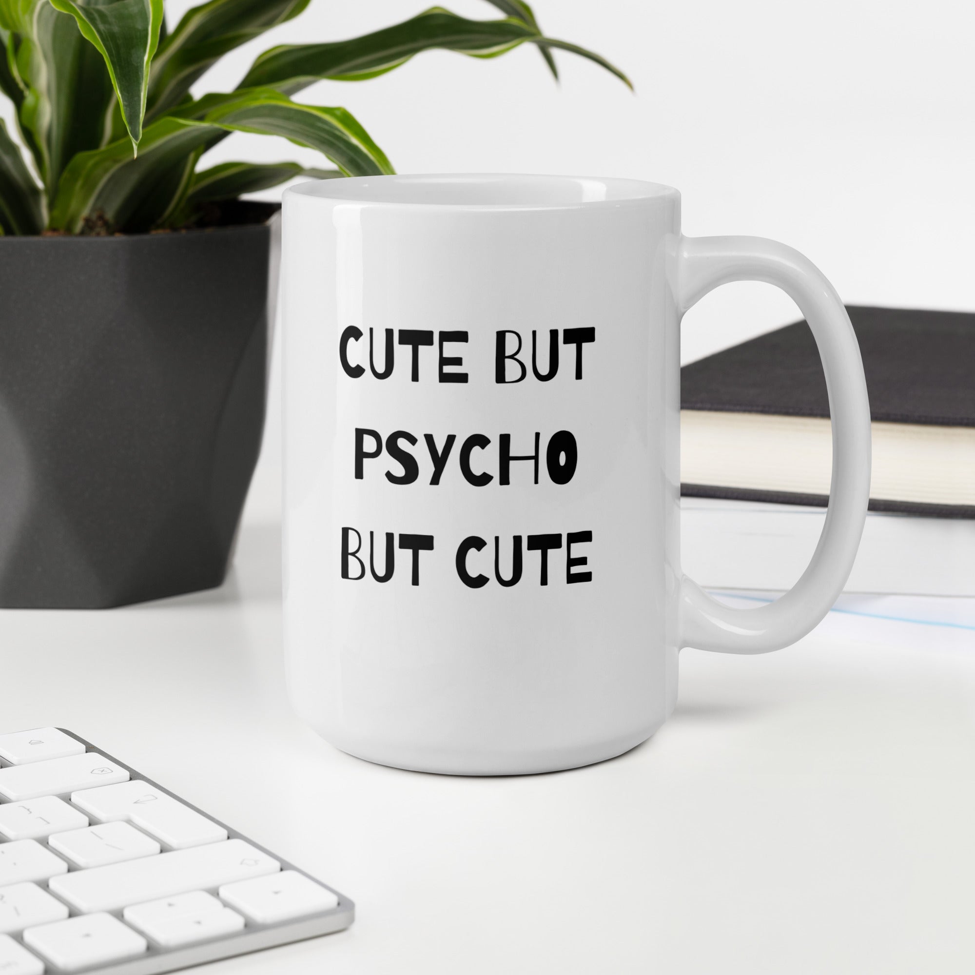 A white ceramic mug with the text &